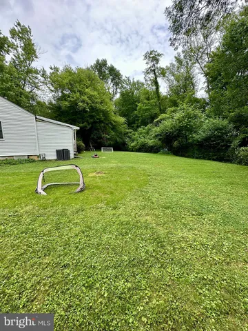 a backyard of a house with a yard and outdoor seating