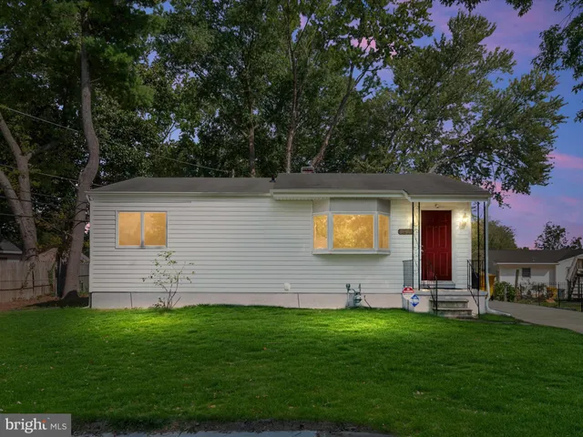 a view of a wooden house with a yard