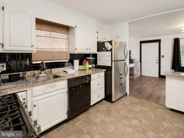 a kitchen with a sink stove and refrigerator