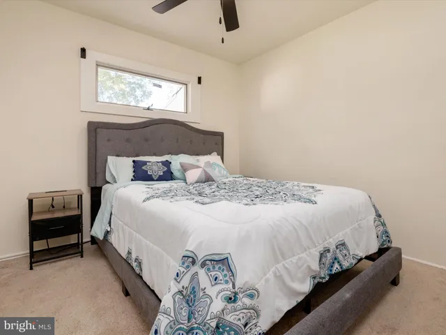 a bedroom with a bed and a night stand