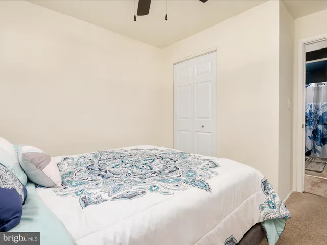 a bedroom with a bed and a potted plant