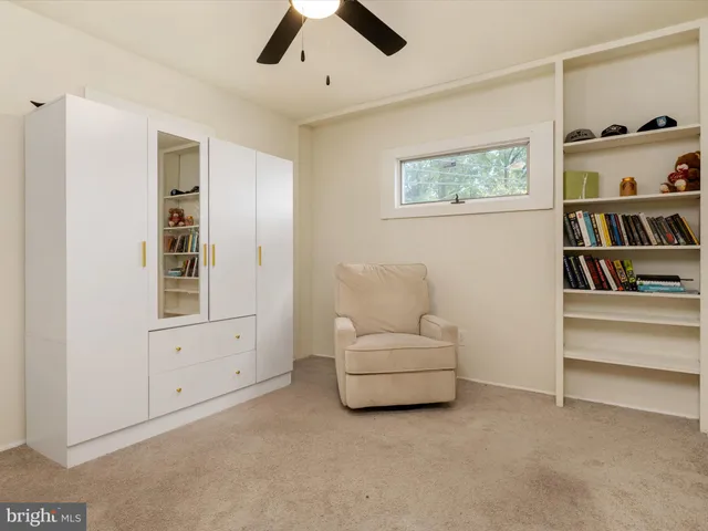 a living room with furniture and white walls