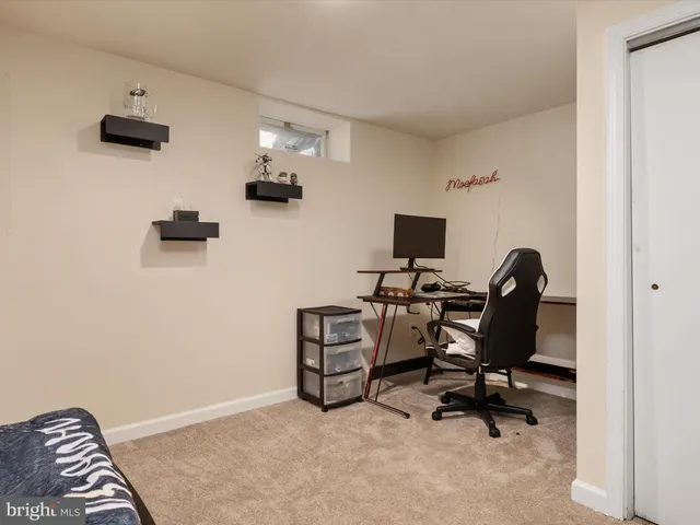 a view of a bedroom with a bed and chair