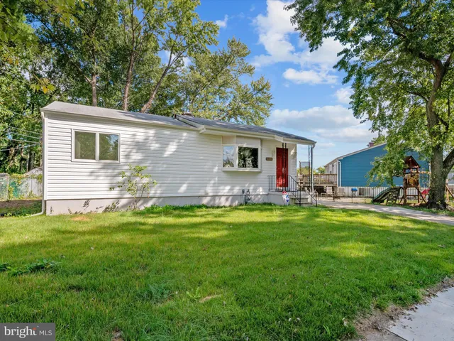 a front view of house with yard barbeque and outdoor seating