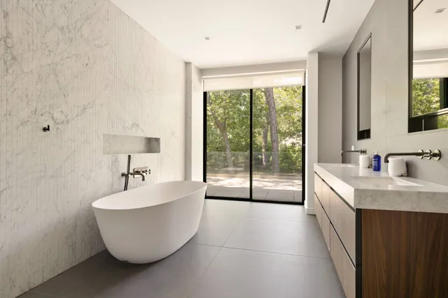 a spacious bathroom with a double vanity sink and a bathtub