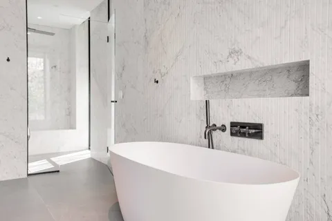 a spacious bathroom with a bathtub and a shower