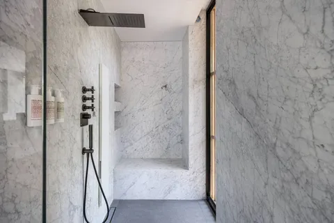 a bathroom with a glass shower door