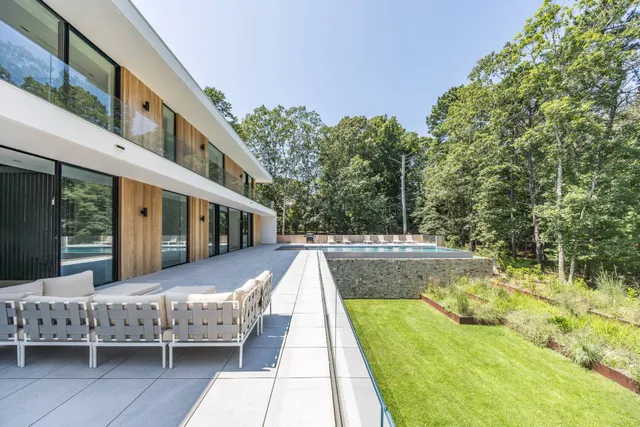 a view of a house with pool and sitting area