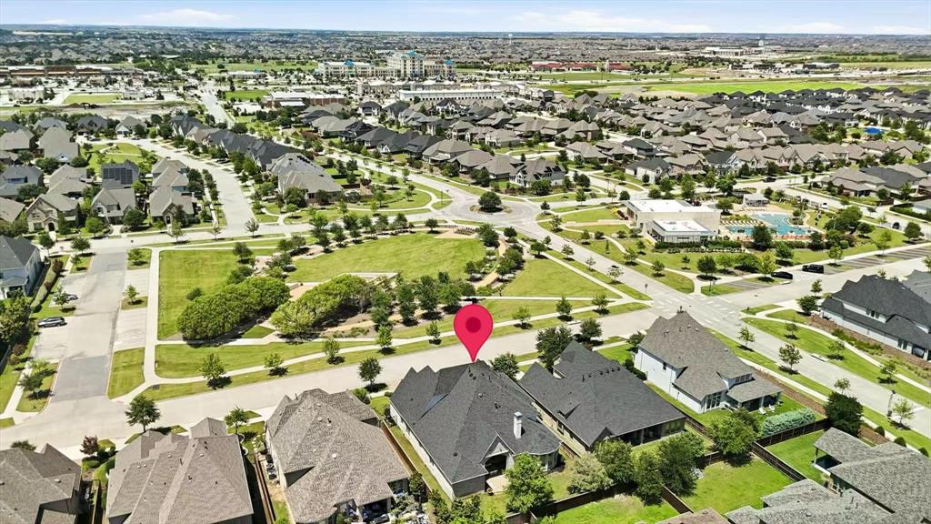 1933 Snapdragon Road Frisco, TX 75033 - Photo 39 of 40 Aerial perspective showcasing a residential area with varied rooflines and a central green space