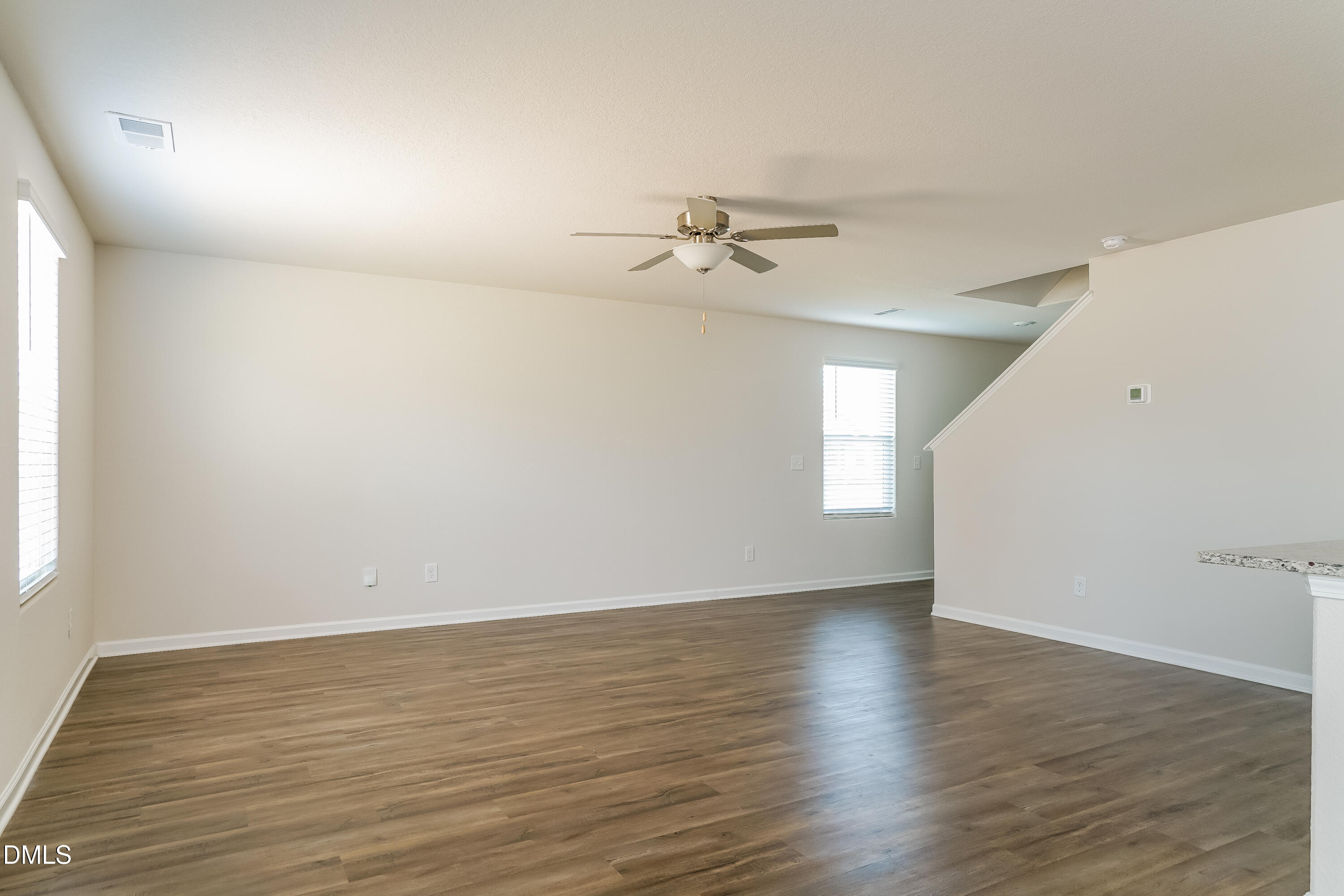 300 Gourd Street Zebulon, NC 27597 - Photo 3 of 17 a view of an empty room with wooden floor and a window