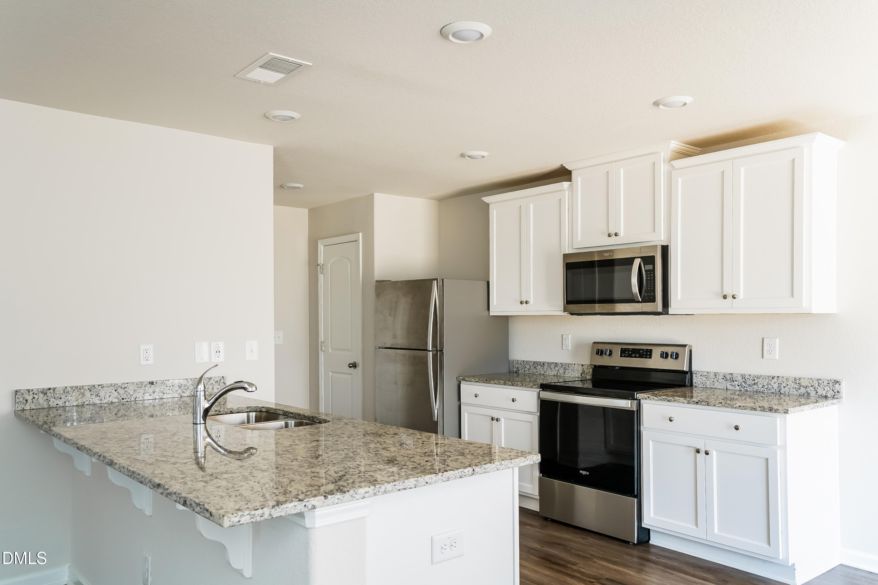 300 Gourd Street Zebulon, NC 27597 - Photo 5 of 17 a kitchen with stainless steel appliances granite countertop a sink stove and refrigerator