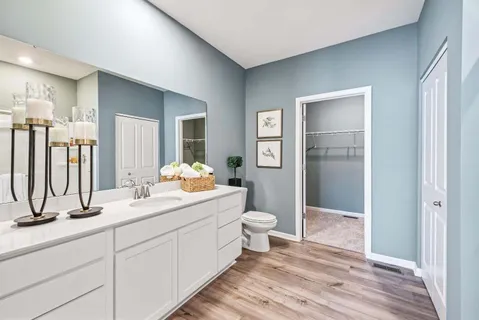 a bathroom with a double vanity sink and mirror