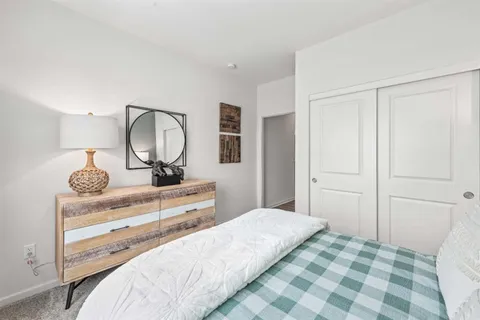 a bedroom with a bed and a mirror