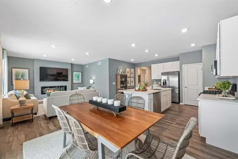 a living room with stainless steel appliances furniture stove and a kitchen view