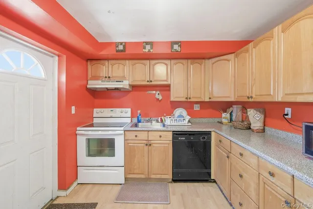 a kitchen with stainless steel appliances granite countertop a stove and cabinets