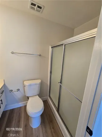 a bathroom with a toilet and a shower