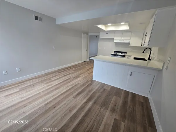 a view of kitchen with sink microwave and stove