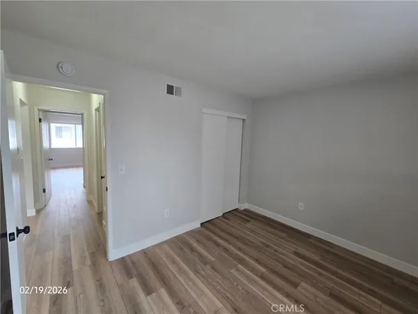 a view of a room with wooden floor
