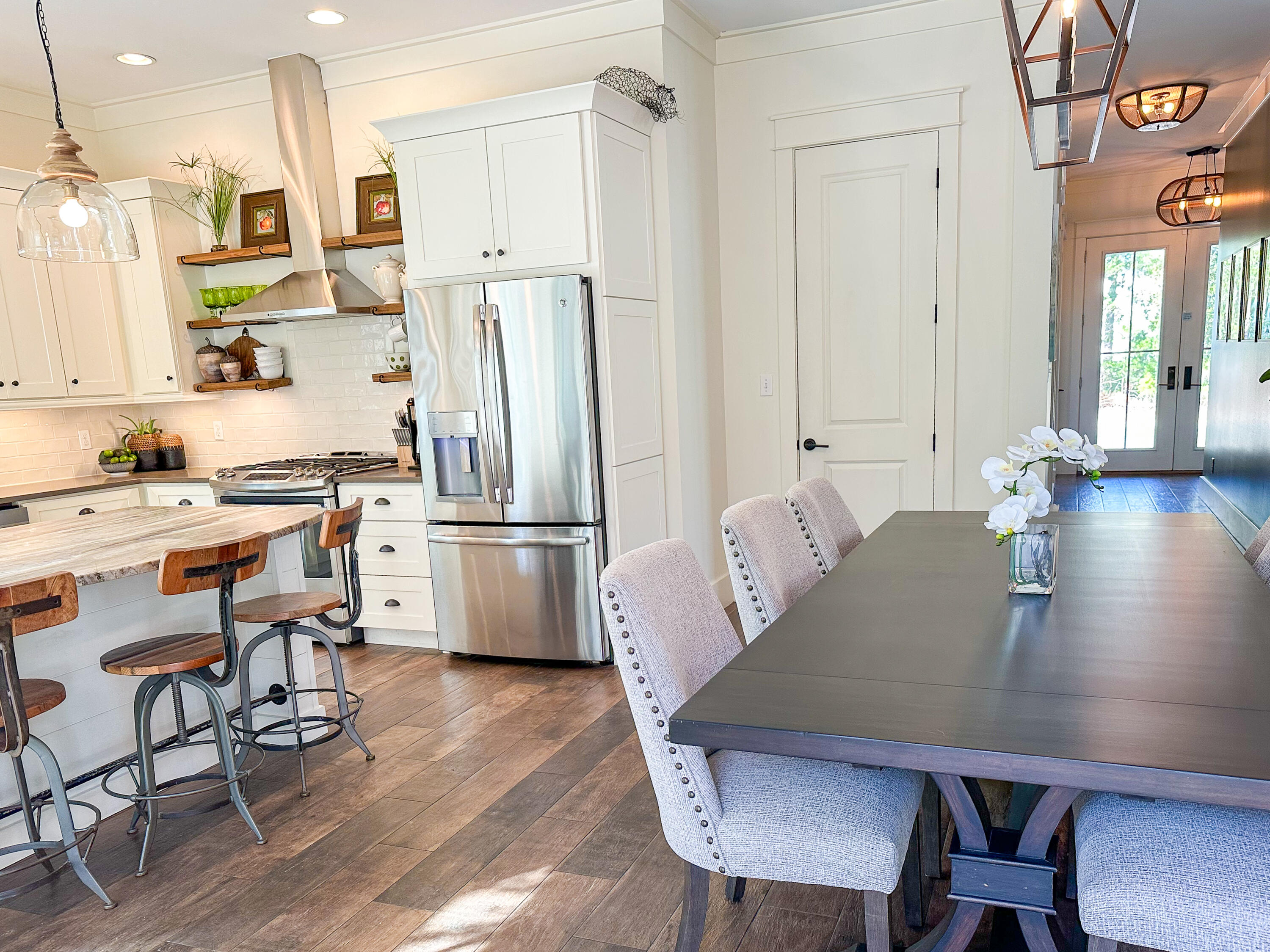 239 Matt's Way Santa Rosa Beach, FL 32459 - Photo 13 of 44 a kitchen with stainless steel appliances a dining table chairs and a refrigerator