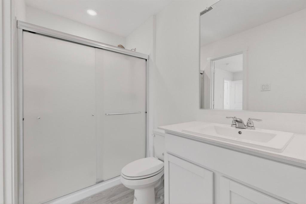 6734 Highlands Street Princeton, TX 75407 - Photo 13 of 40 a bathroom with a sink a toilet and a mirror