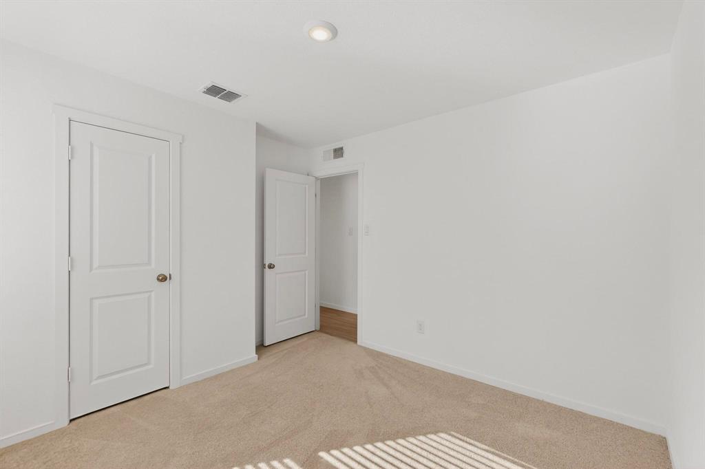 6734 Highlands Street Princeton, TX 75407 - Photo 20 of 40 Unfurnished bedroom featuring light colored carpet and baseboards