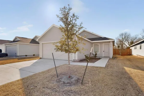 a view of a house with a yard and garage