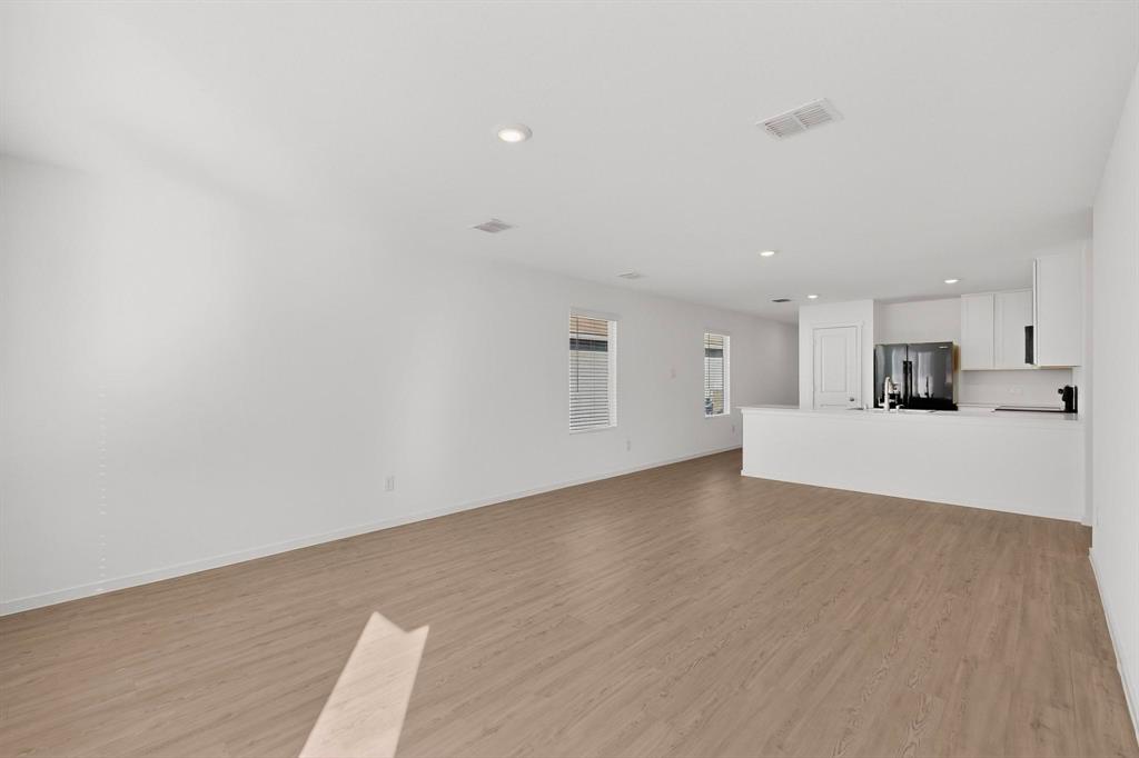 6734 Highlands Street Princeton, TX 75407 - Photo 25 of 40 a view of empty room with wooden floor