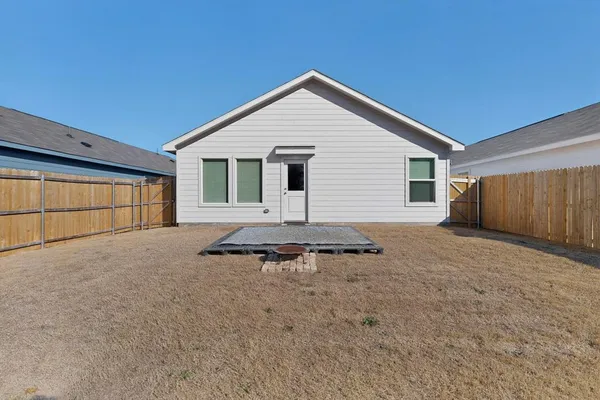 a view of a house with wooden fence