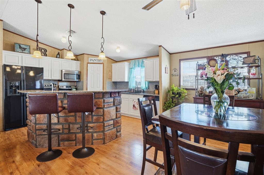 224 Cactus Ridge Court Springtown, TX 76082 - Photo 17 of 39 Dining room with crown molding, light wood-type flooring, lofted ceiling, and ceiling fan