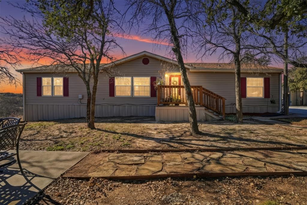 224 Cactus Ridge Court Springtown, TX 76082 - Photo 2 of 39 Evening view of home