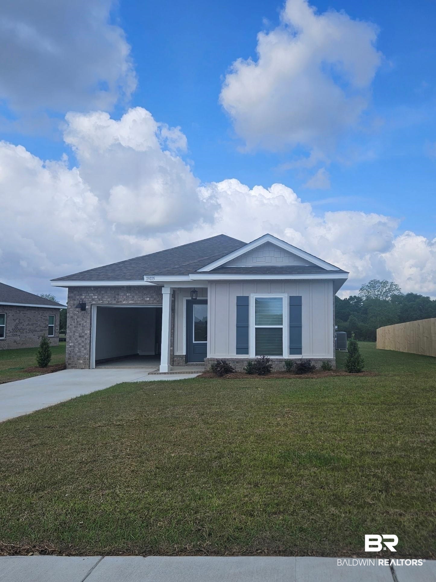 19115 Treehill Lane Summerdale, AL 36580 - Photo 1 of 30 Ranch-style home with driveway, a front yard, board and batten siding, and a garage