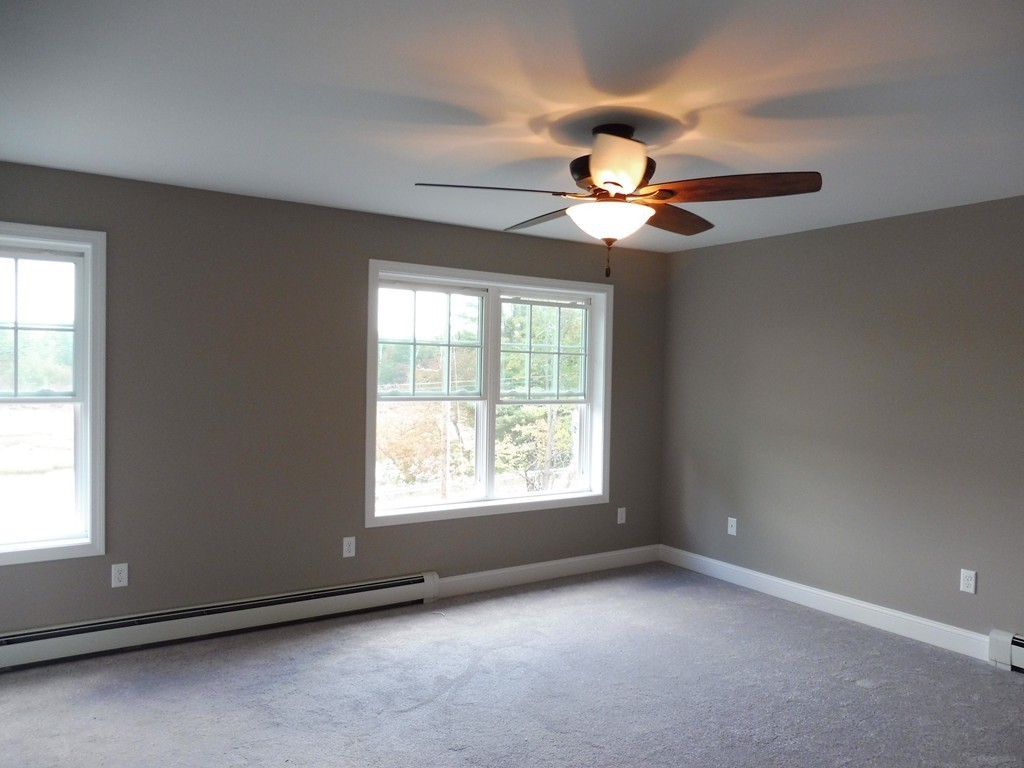 9 Depot Road Ashburnham, MA 01430 - Photo 12 of 16 a view of an empty room with windows and chandelier fan