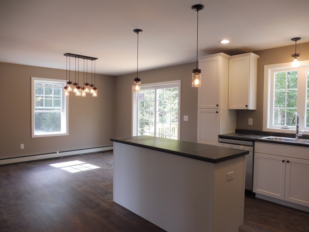9 Depot Road Ashburnham, MA 01430 - Photo 3 of 16 a kitchen with granite countertop a stove a sink a window and wooden floor