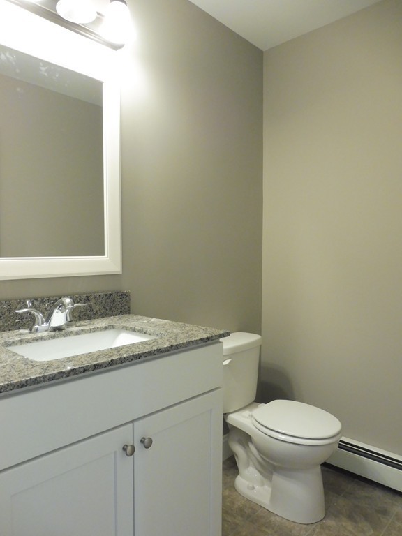 9 Depot Road Ashburnham, MA 01430 - Photo 5 of 16 a bathroom with a granite countertop toilet and a sink