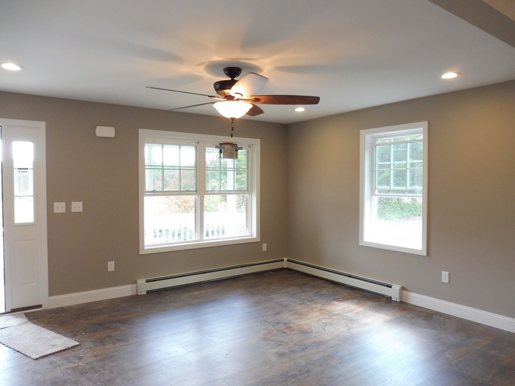 9 Depot Road Ashburnham, MA 01430 - Photo 7 of 16 an empty room with wooden floor and windows