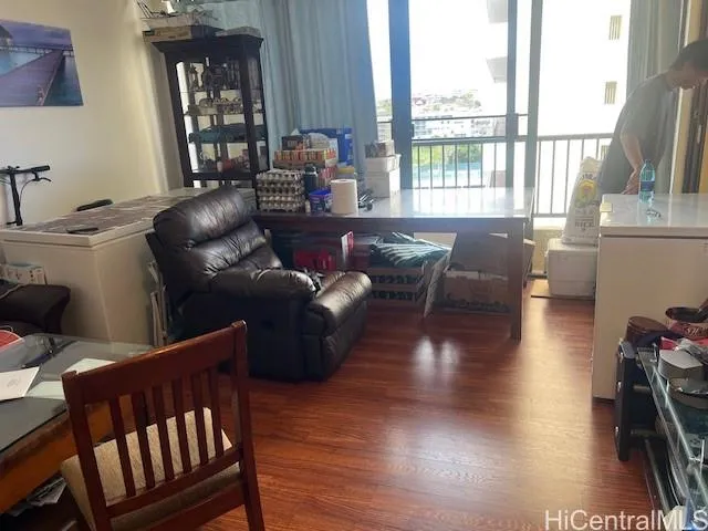 a living room with furniture and a floor to ceiling window