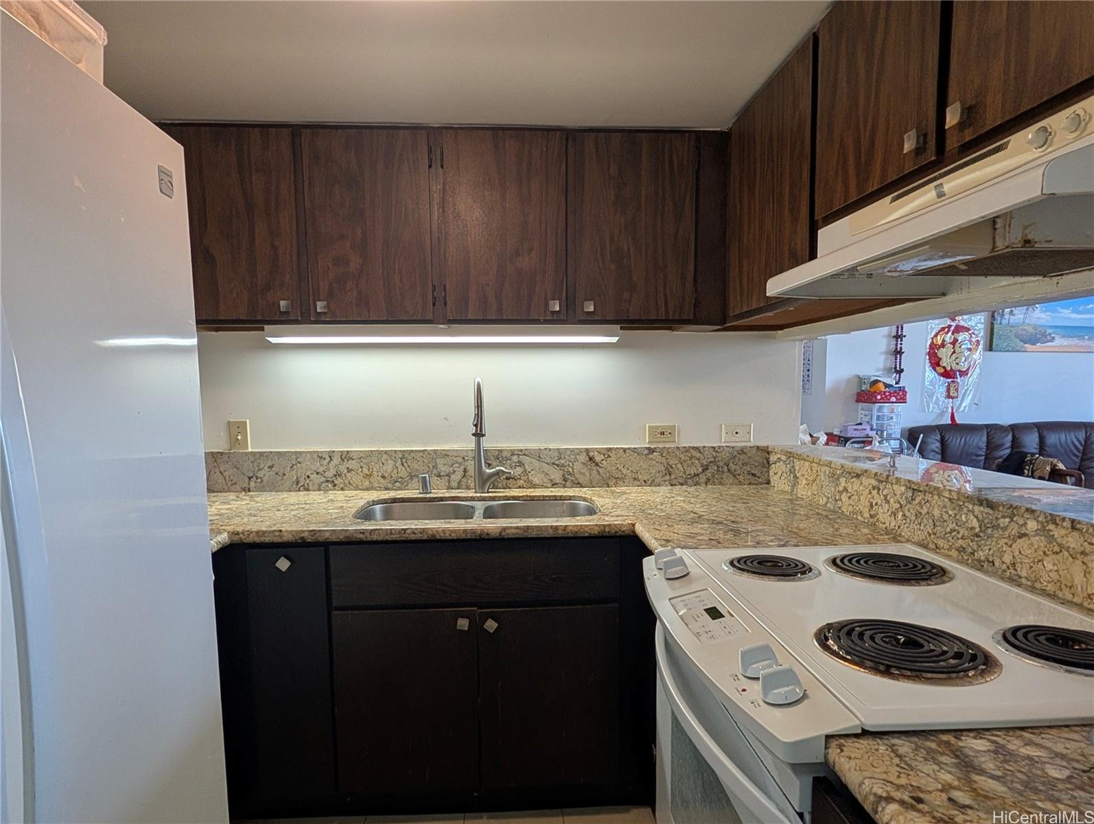 3130 Ala Ilima Street, Unit 10C Honolulu, HI 96818 - Photo 5 of 11 a kitchen with a sink a stove and cabinets