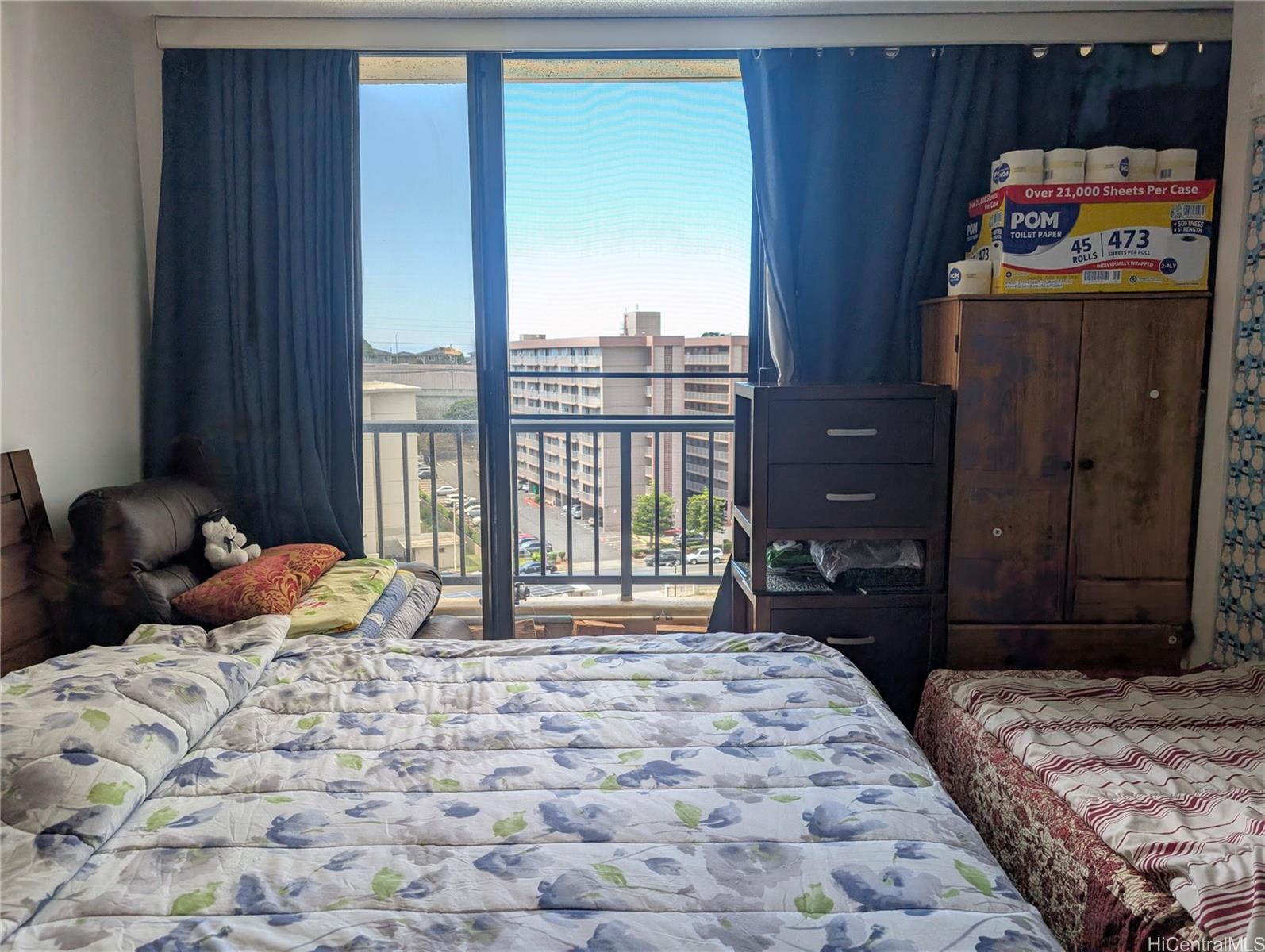 3130 Ala Ilima Street, Unit 10C Honolulu, HI 96818 - Photo 6 of 11 a bedroom with a bed and a large window