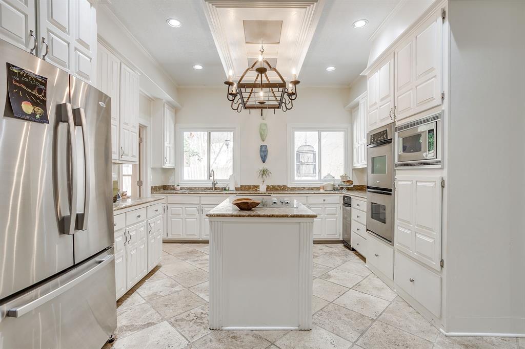 1805 Burton Hill Road Fort Worth, TX 76107 - Photo 13 of 39 a kitchen with white cabinets and appliances