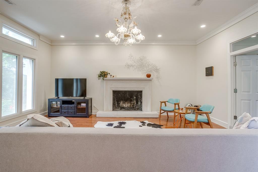 1805 Burton Hill Road Fort Worth, TX 76107 - Photo 19 of 39 a living room with furniture a fireplace and a flat screen tv
