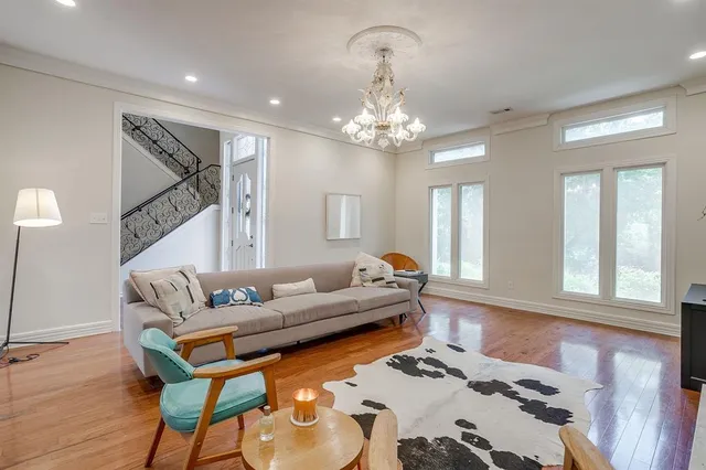 a living room with furniture and a chandelier