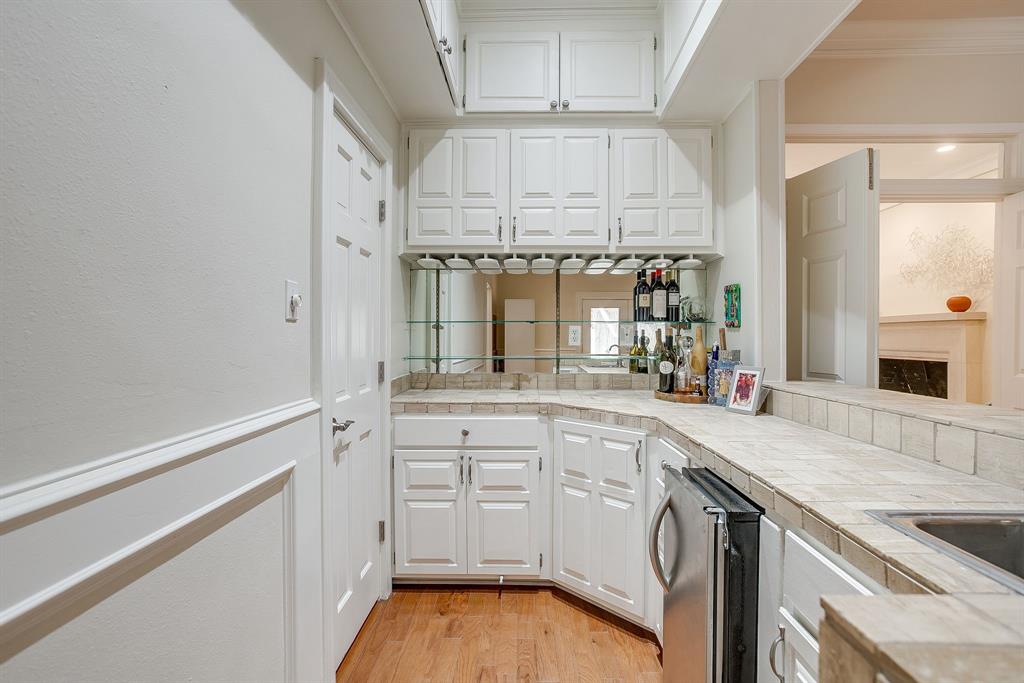 1805 Burton Hill Road Fort Worth, TX 76107 - Photo 22 of 39 a kitchen with granite countertop white cabinets and white appliances