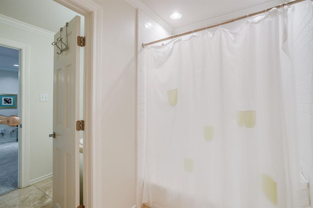 1805 Burton Hill Road Fort Worth, TX 76107 - Photo 31 of 39 a bathroom with a shower and a curtain
