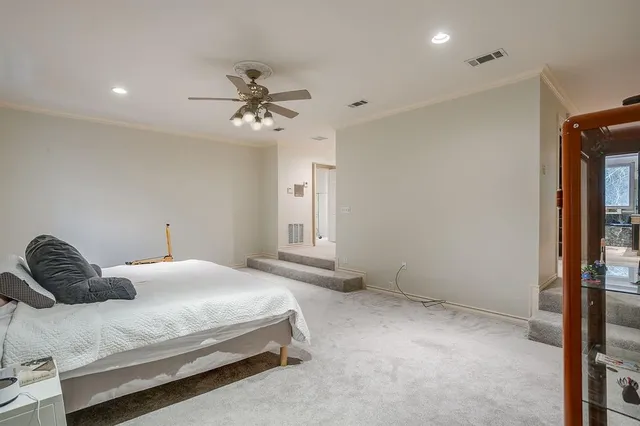 a bedroom with a bed and a ceiling fan