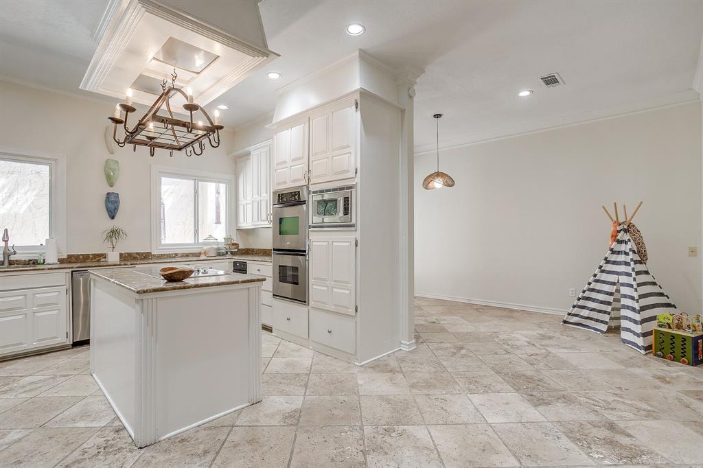 1805 Burton Hill Road Fort Worth, TX 76107 - Photo 10 of 39 a kitchen with kitchen island granite countertop a refrigerator and a sink