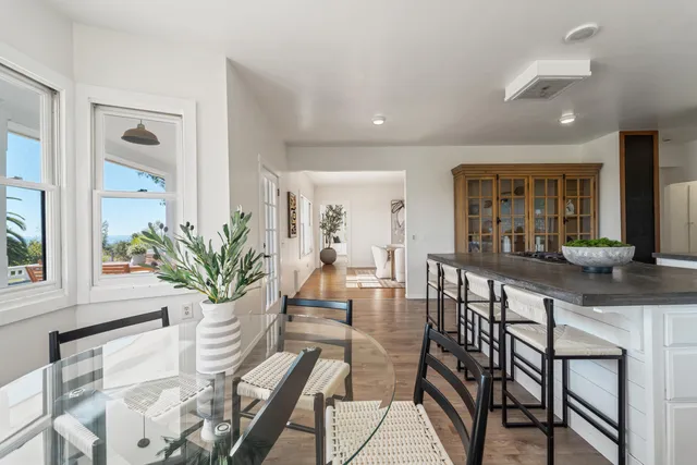 a kitchen with a table chairs and a view of living room
