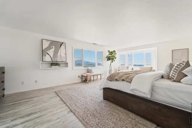 a bedroom with bed couch and window