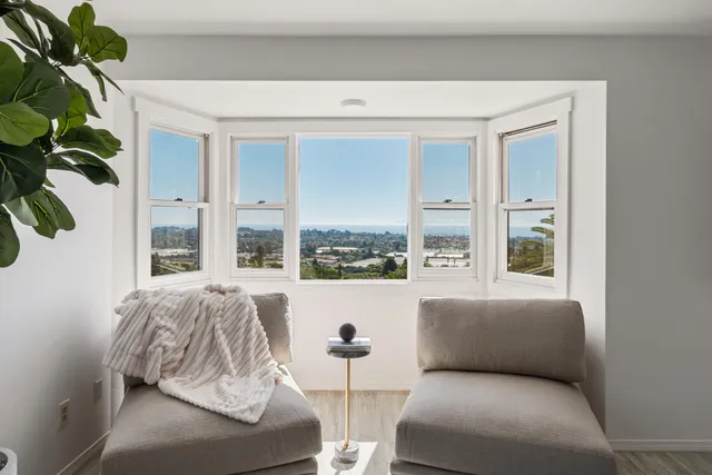 a living room with furniture and a potted plant