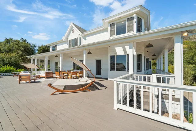 a view of a building with sitting area and garden