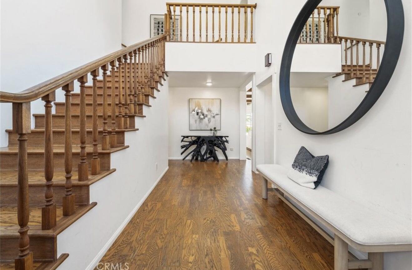 4508 Foothill Road Carpinteria, CA 93013 - Photo 6 of 31 a living room with wooden floor furniture and a chandelier